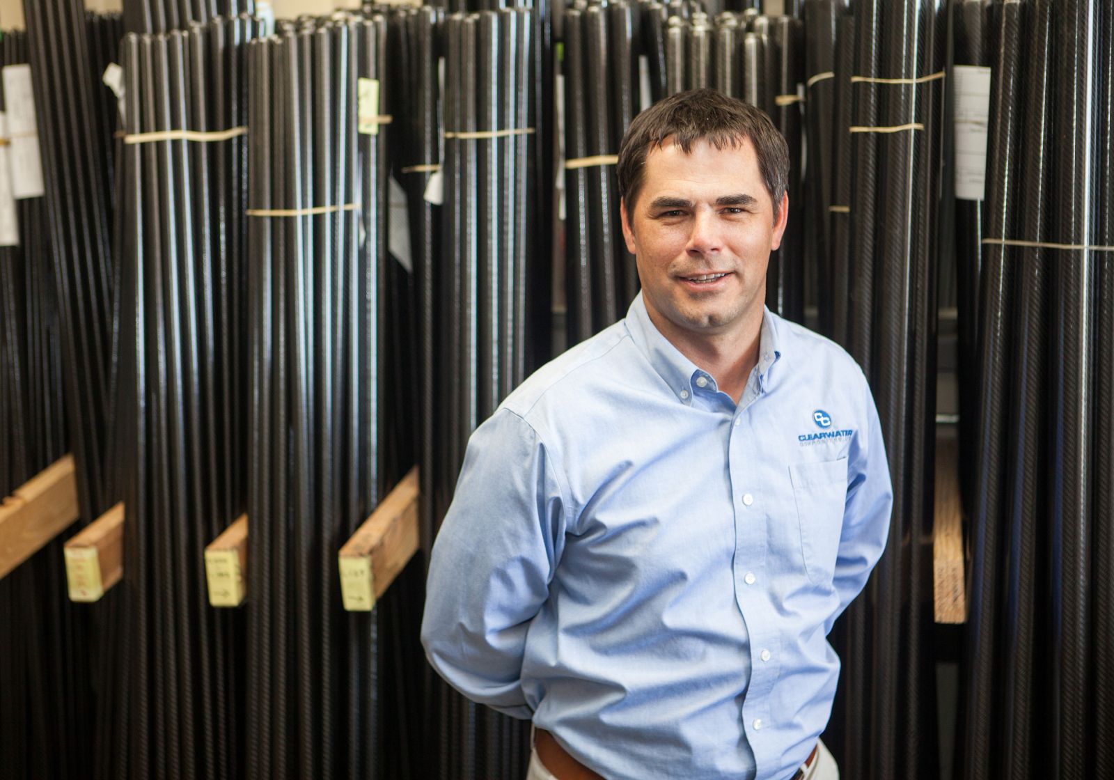 Man standing in front of Carbon Fiber Tubes